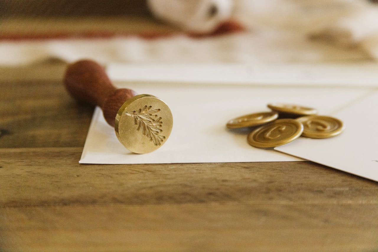 my-qualifications Close-up of a wax seal on an envelope with coins, creating a vintage still life.